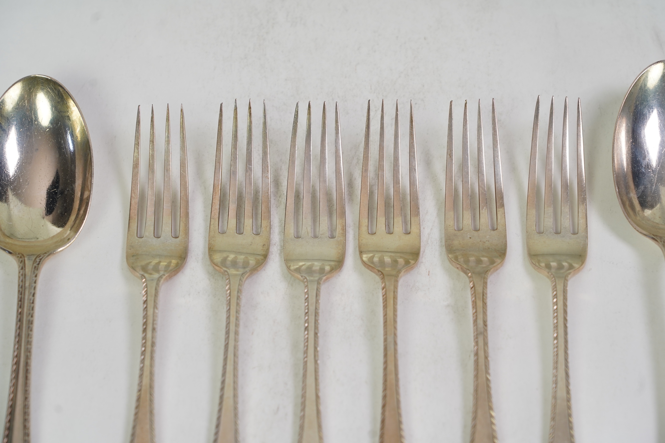 A set of six George V fancy Old English pattern table spoons by Elkington & Co, Birmingham, 1919, 22.2cm, together with a set of six fancy Hanoverian pattern table forks, Goldsmiths & Silversmiths Co Ltd, London, 1918, 3